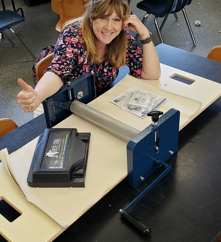 Woman at a desk giving thumbs up